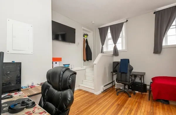a view of a workspace with furniture and gym equipment