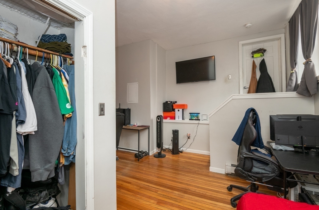 96 Derby Street, Unit 1 Salem, MA 01970 - Photo 20 of 31 a view of a workspace with furniture and a flat screen tv