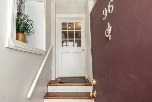 a view of staircase with white walls and a window