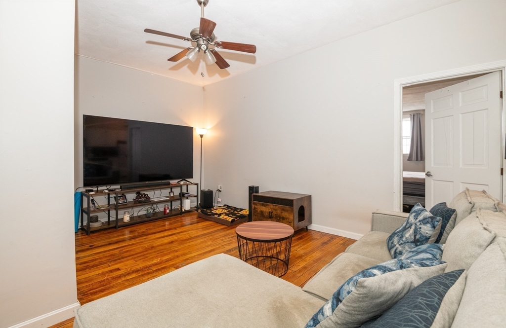 96 Derby Street, Unit 1 Salem, MA 01970 - Photo 10 of 31 a living room with furniture and a flat screen tv