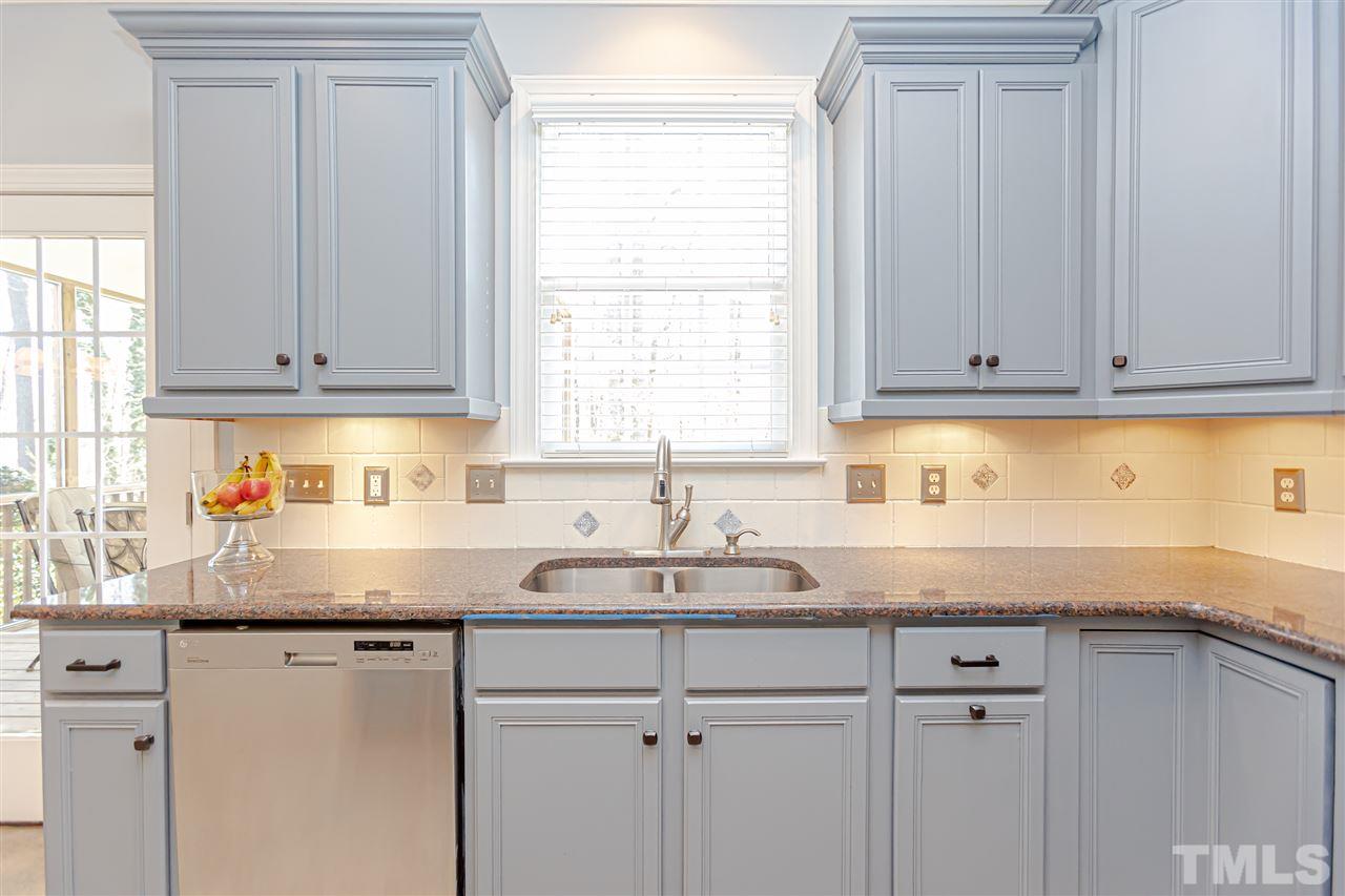 9408 Ray Road Raleigh, NC 27613 - Photo 12 of 30 a kitchen with granite countertop white cabinets and a sink