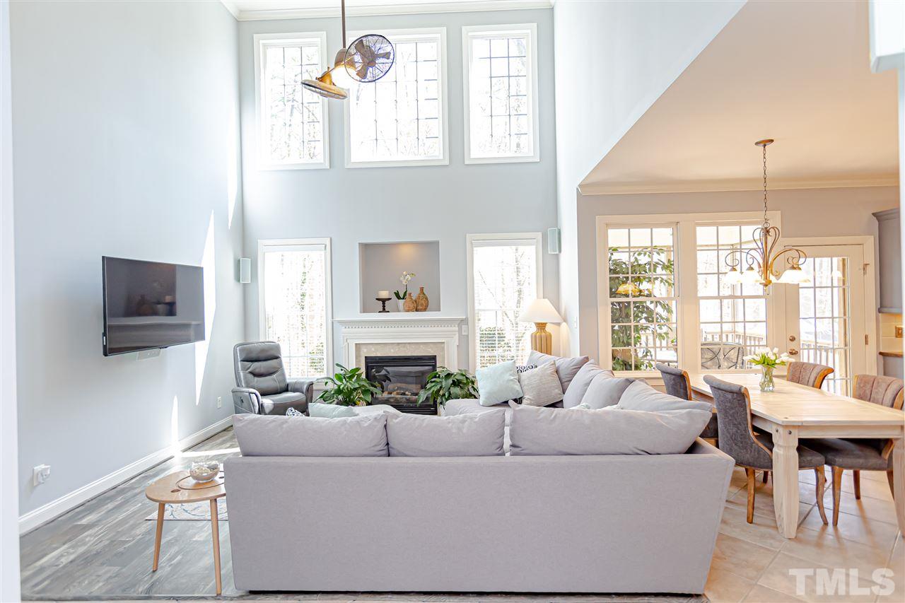 9408 Ray Road Raleigh, NC 27613 - Photo 13 of 30 a living room with furniture a flat screen tv and a large window