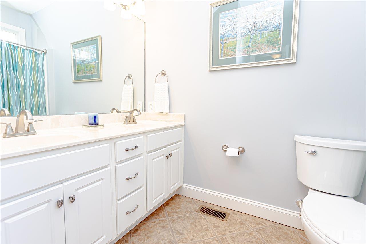 9408 Ray Road Raleigh, NC 27613 - Photo 15 of 30 a bathroom with a toilet sink and mirror