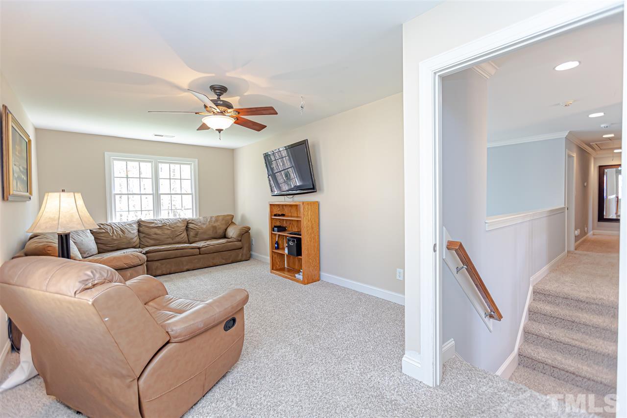 9408 Ray Road Raleigh, NC 27613 - Photo 16 of 30 a living room with furniture and a flat screen tv