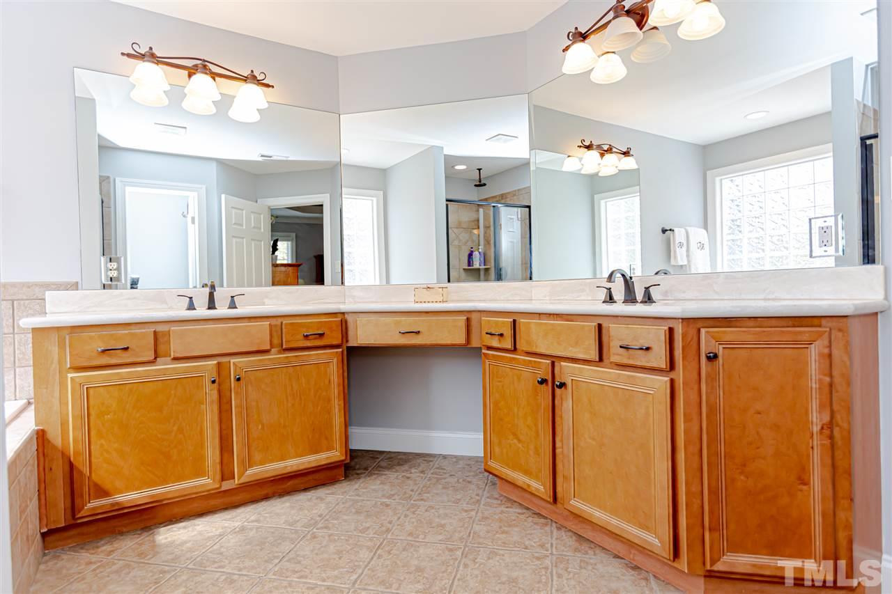 9408 Ray Road Raleigh, NC 27613 - Photo 20 of 30 a bathroom with a granite countertop sink and a mirror