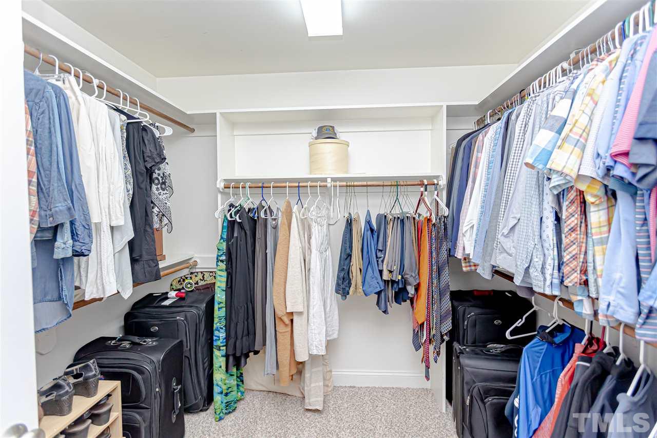 9408 Ray Road Raleigh, NC 27613 - Photo 22 of 30 a view of walk in closet with clothes and shoes