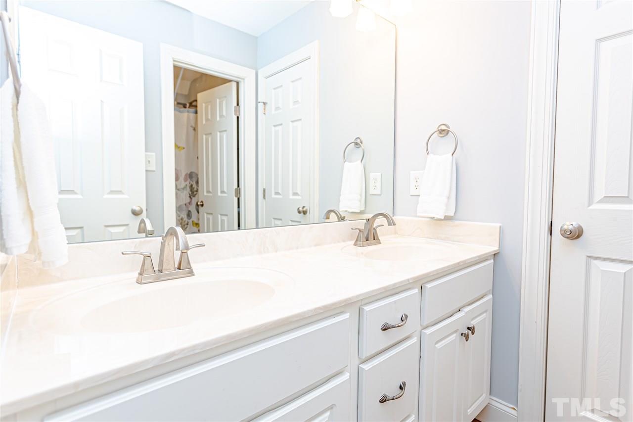 9408 Ray Road Raleigh, NC 27613 - Photo 24 of 30 a bathroom with a sink and a mirror