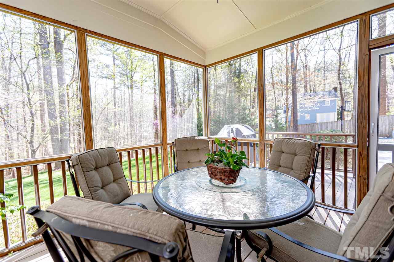 9408 Ray Road Raleigh, NC 27613 - Photo 27 of 30 a dining room with furniture wooden floor and a potted plant