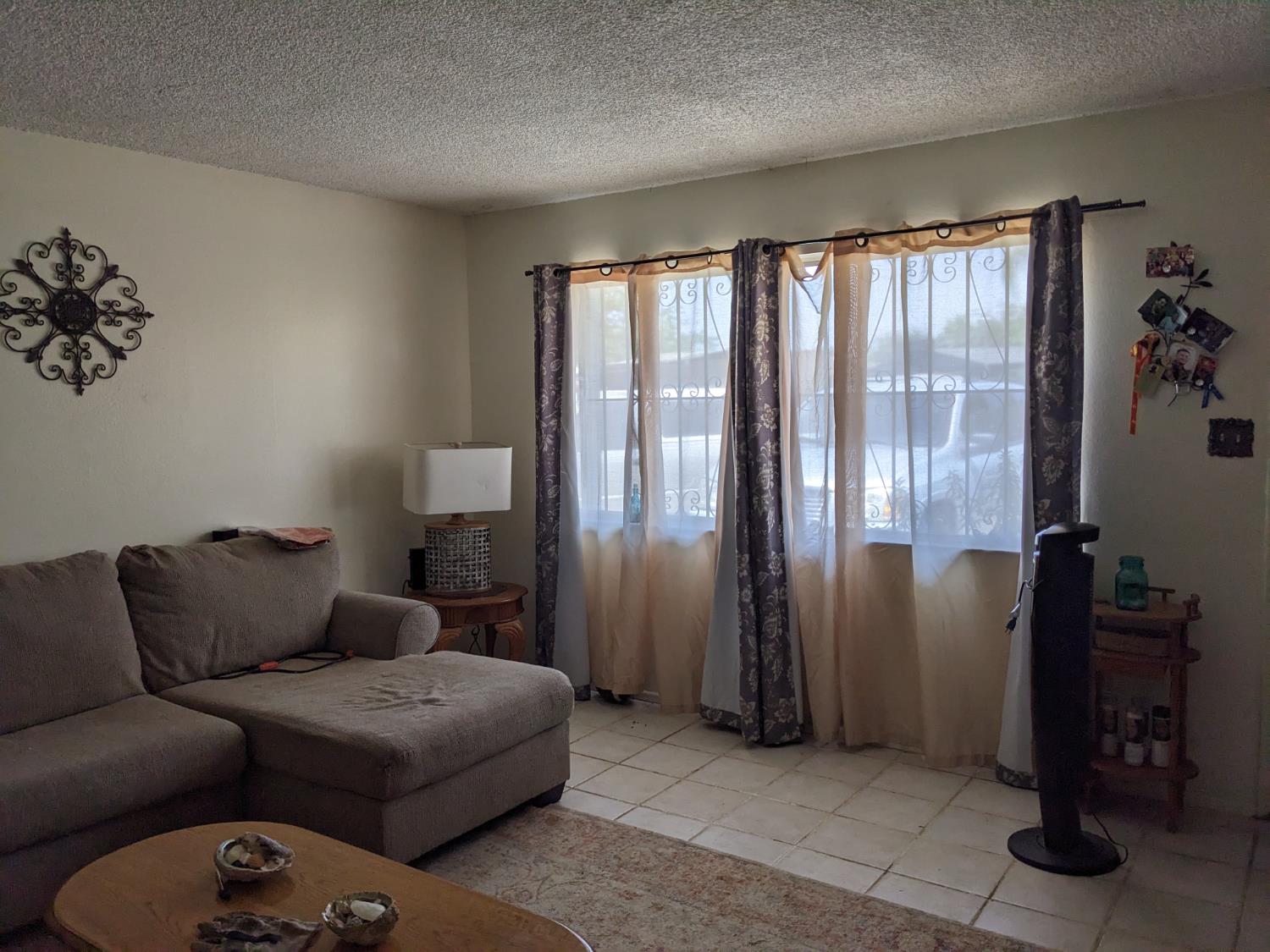 3607 Periwinkle Court Bakersfield, CA 93307 - Photo 3 of 13 a living room with furniture and a window