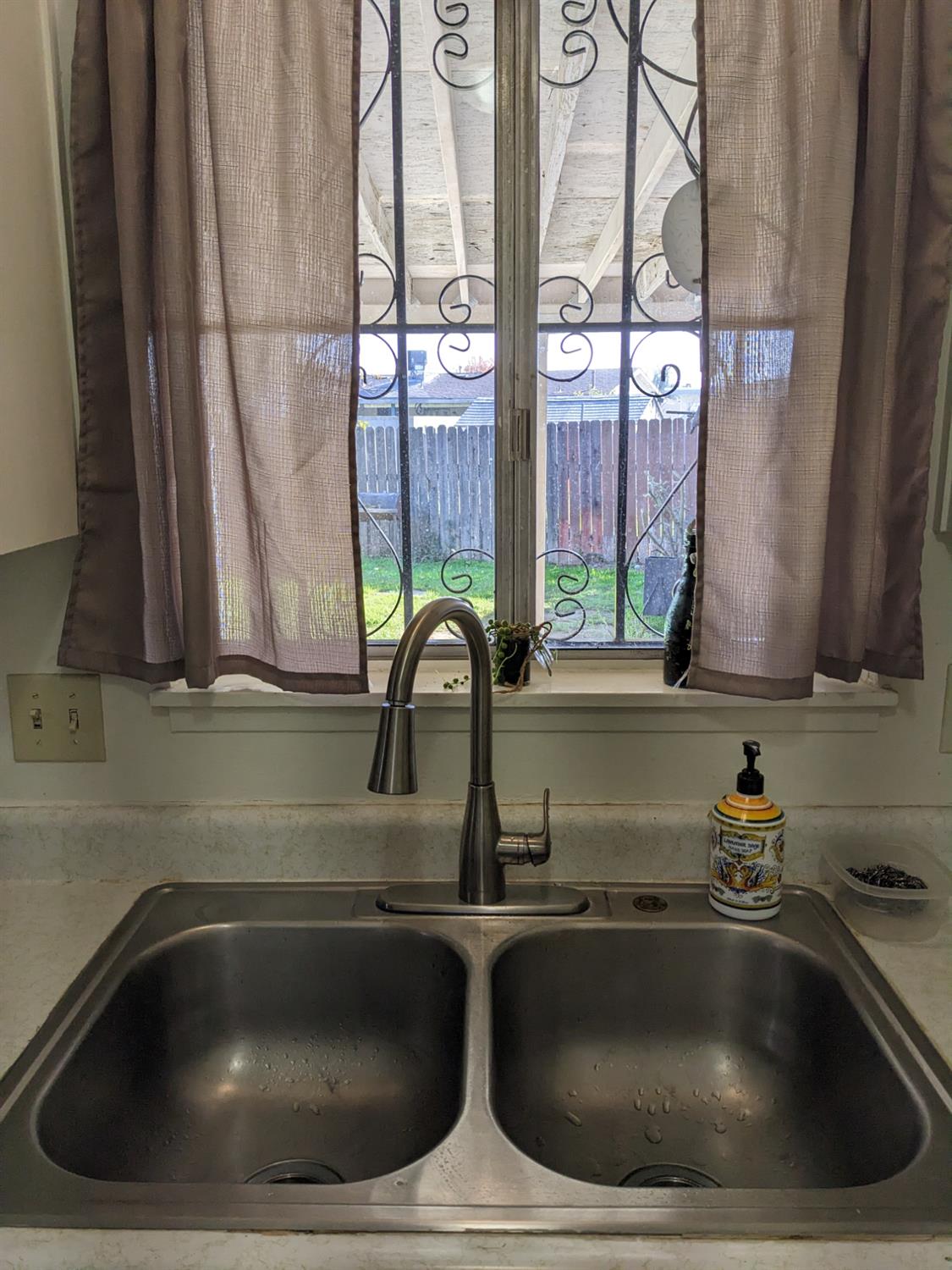 3607 Periwinkle Court Bakersfield, CA 93307 - Photo 5 of 13 a kitchen with a sink a counter space and a window