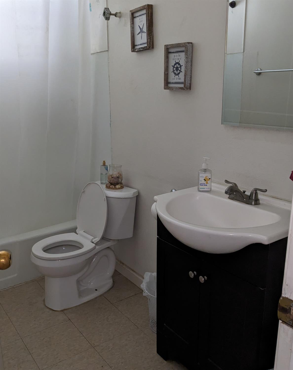 3607 Periwinkle Court Bakersfield, CA 93307 - Photo 6 of 13 a bathroom with a sink toilet and a mirror