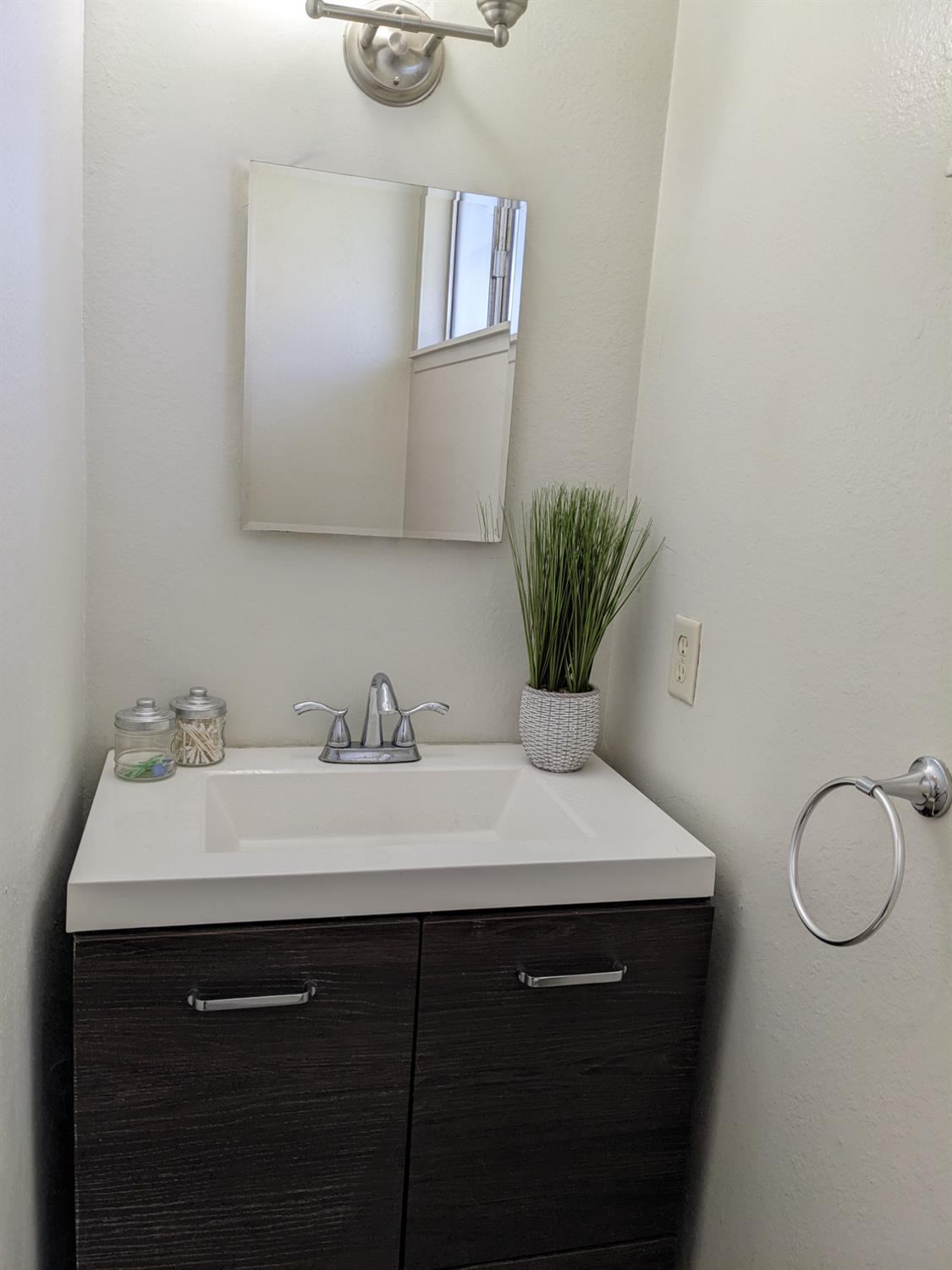 3607 Periwinkle Court Bakersfield, CA 93307 - Photo 9 of 13 a bathroom with a sink and a mirror