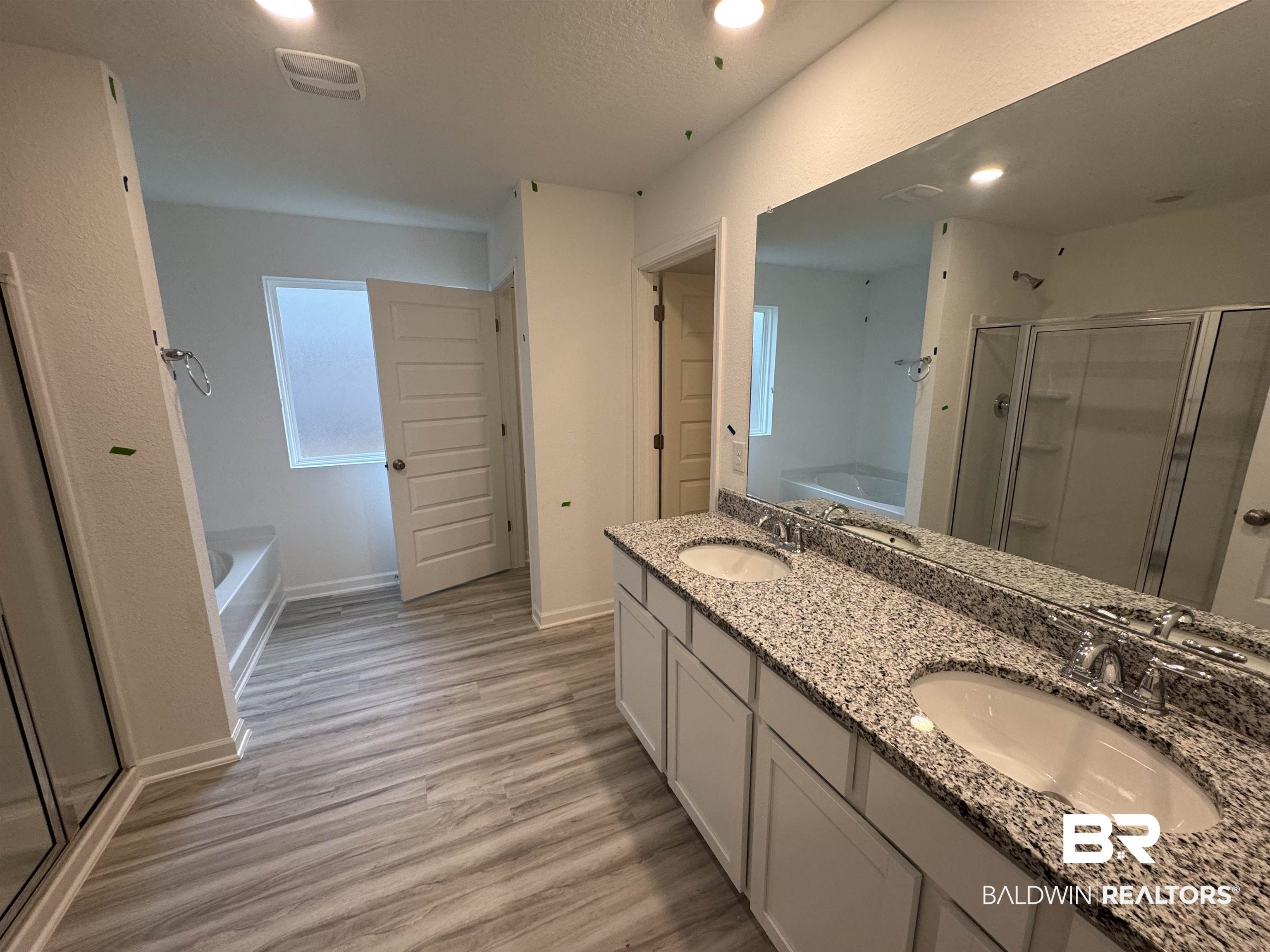24431 Ringneck Loop Elberta, AL 36530 - Photo 13 of 15 Bathroom featuring hardwood / wood-style floors, vanity, separate shower and tub, and a textured ceiling