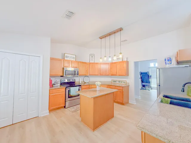 a kitchen with cabinets and wooden floor