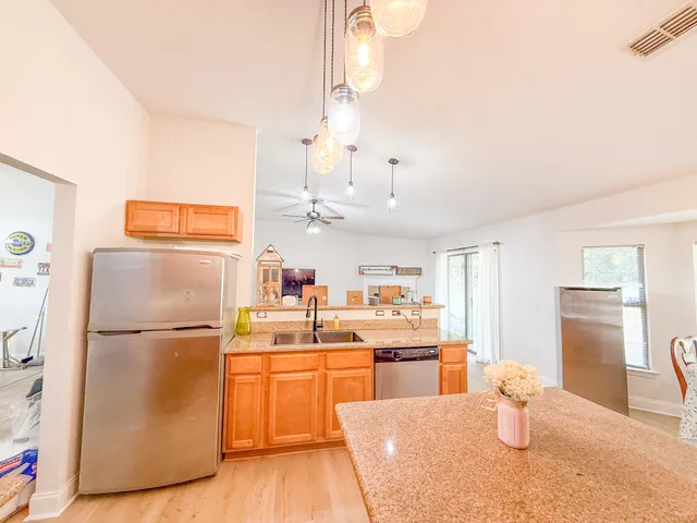 a kitchen with a refrigerator and a sink