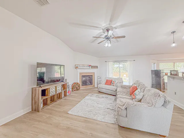a living room with furniture fireplace and flat screen tv