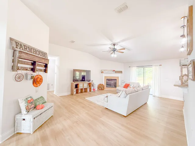 a living room with hard wood floor and furniture