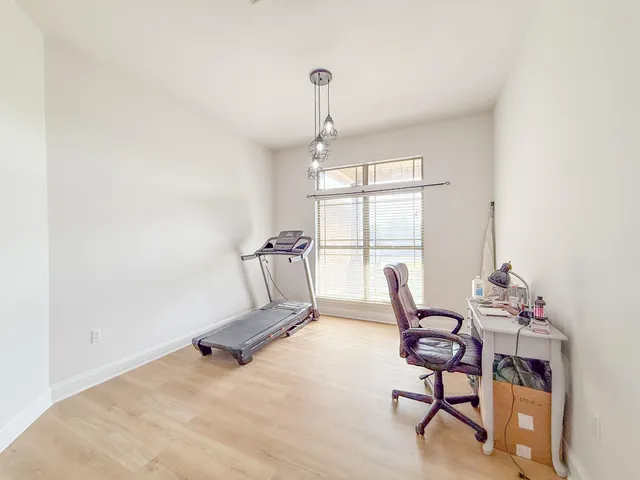 a dining room with furniture and a window