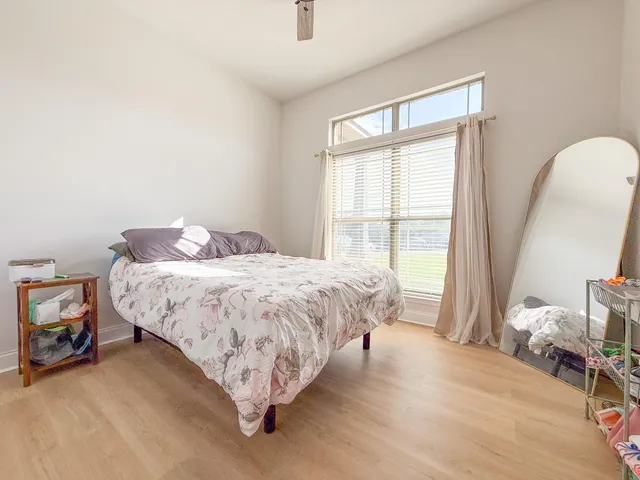 a bed sitting in a bedroom next to a window