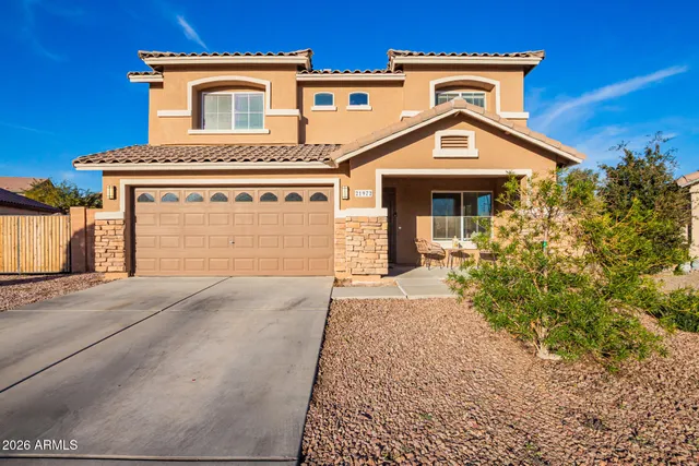 a front view of a house with a yard and garage