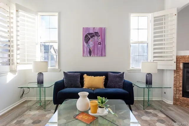 a blue couch sitting in a living room next to a window