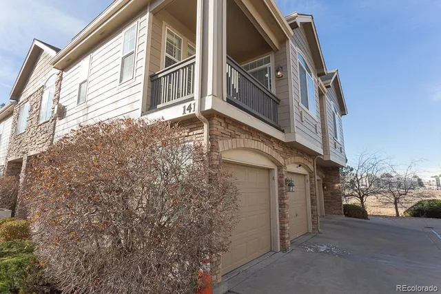 a view of a house with a large tree