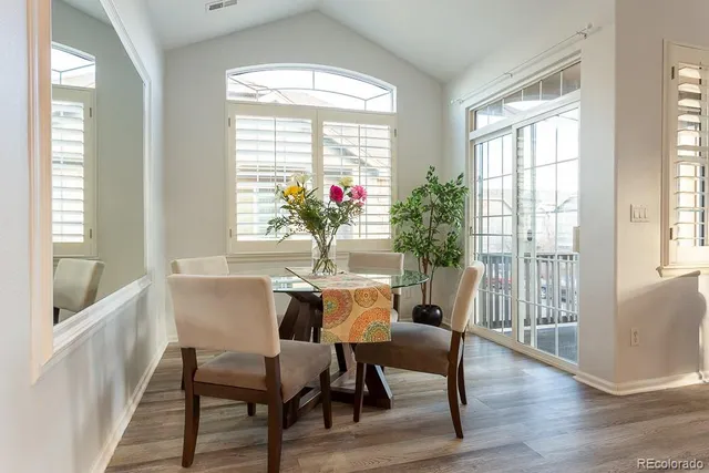 a view of a dining room with furniture window and wooden floor