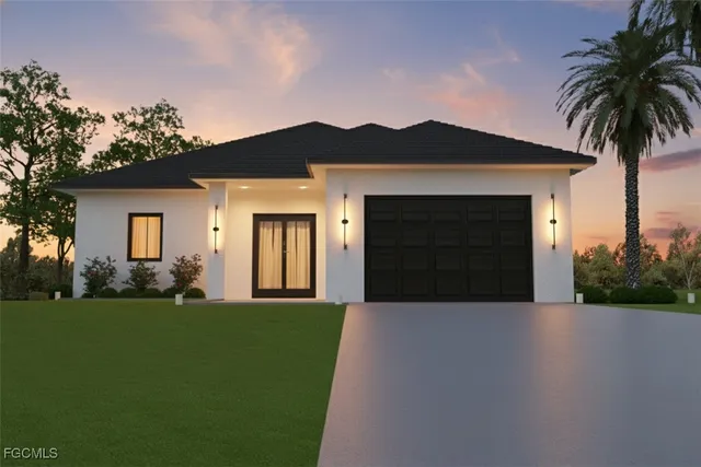 a front view of a house with a garden and yard