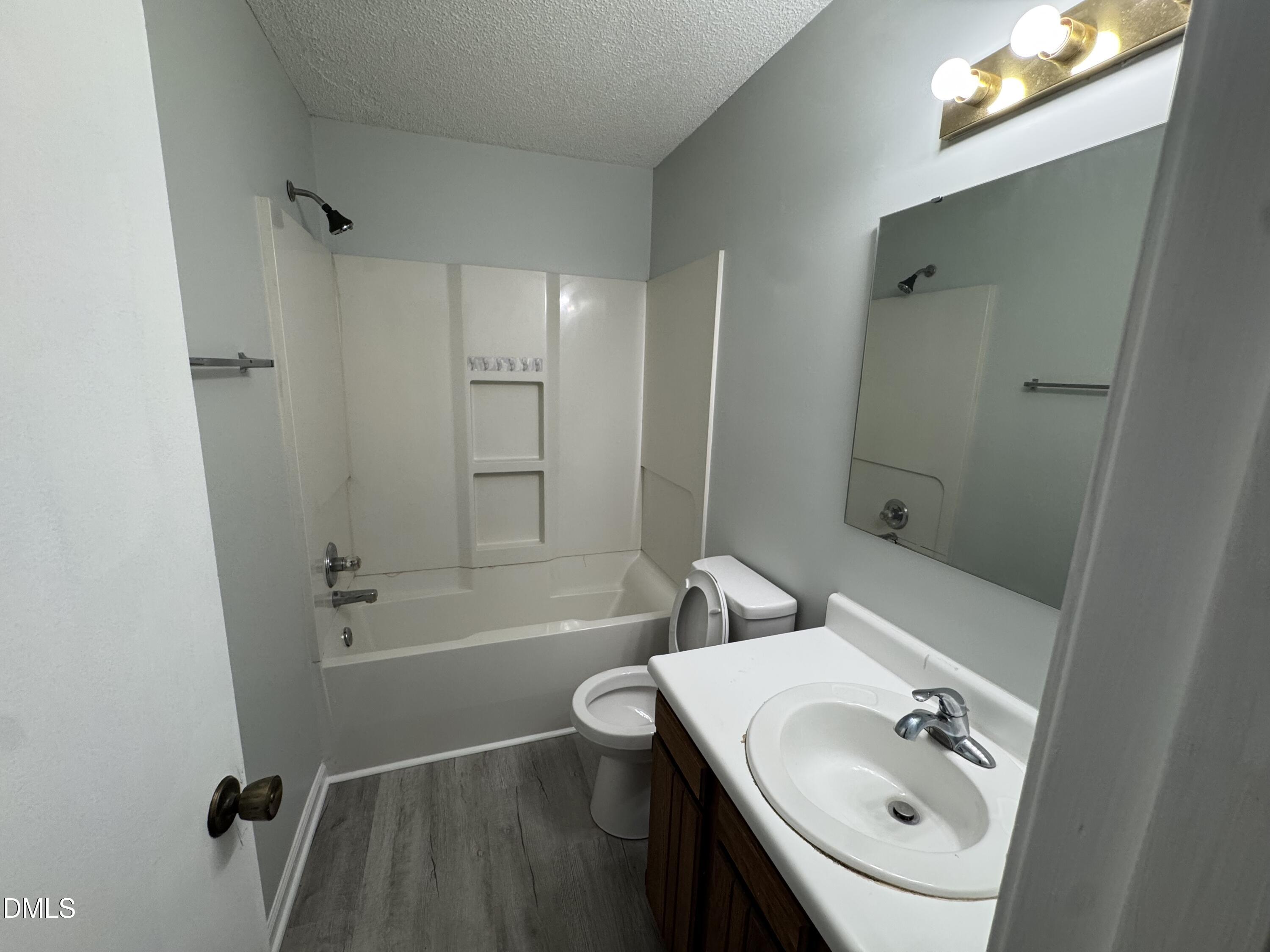 4200 Bertram Drive Raleigh, NC 27604 - Photo 9 of 16 a bathroom with a sink a toilet and shower