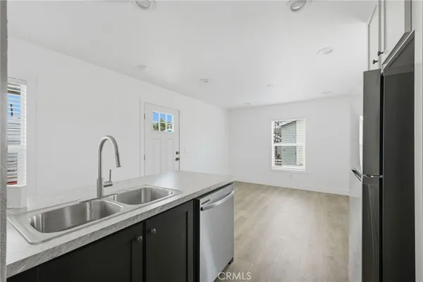 a kitchen with a sink and a refrigerator