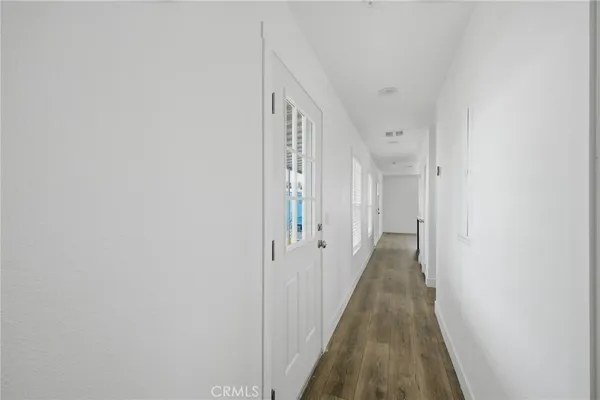 a view of a hallway with a wooden floor