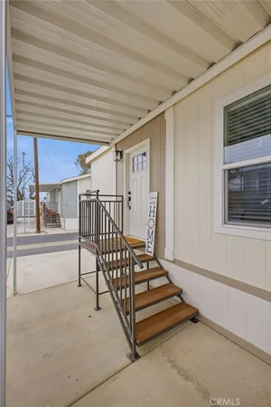 a view of a porch with furniture and floor to ceiling window
