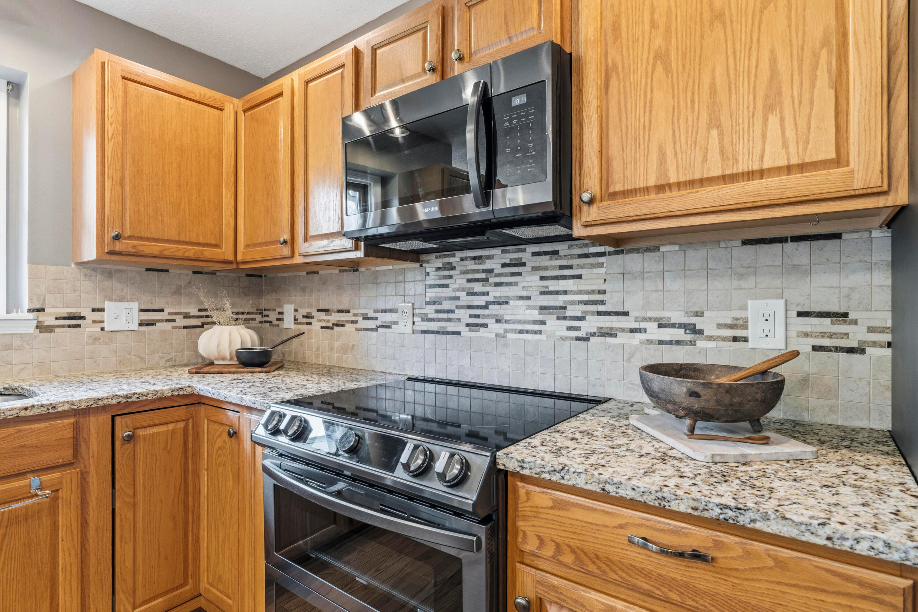 8507 Benner Road Johnstown, OH 43031 - Photo 19 of 69 Large Kitchen with hardwood floors and Dining Area with bay window & double fireplace! Granite countertops, island, NEW Black Stainless Steel Appliances, including an induction oven! NEW Reverse Osmosis to sink/Fridge/Brio+