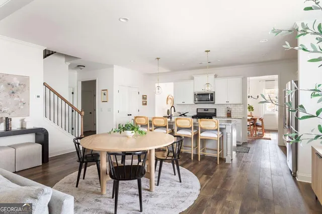 a view of a dining room with furniture and wooden floor