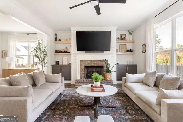 a living room with furniture fireplace and a flat screen tv