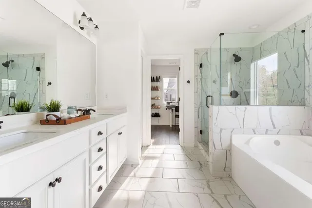 a bathroom with a tub sink and mirror