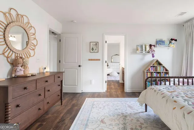 a bedroom with a bed and a dresser