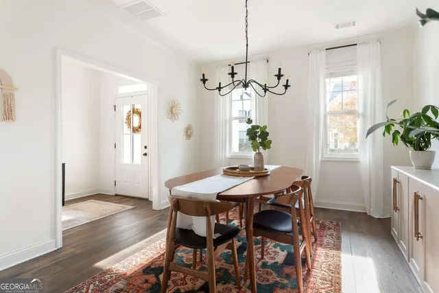 a view of a dining room with furniture window and wooden floor
