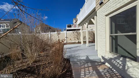 a kitchen with granite countertop white cabinets and stainless steel appliances