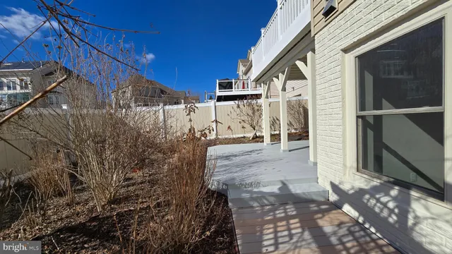 a kitchen with granite countertop white cabinets and stainless steel appliances