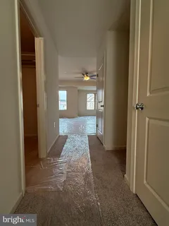 a kitchen with stainless steel appliances granite countertop a refrigerator a stove a sink dishwasher and white cabinets with wooden floor