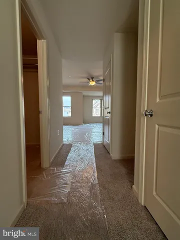 a kitchen with stainless steel appliances granite countertop a refrigerator a stove a sink dishwasher and white cabinets with wooden floor