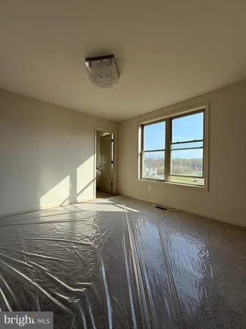 a spacious bathroom with a tub shower and window