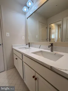 a view of an empty room with closet and bathroom