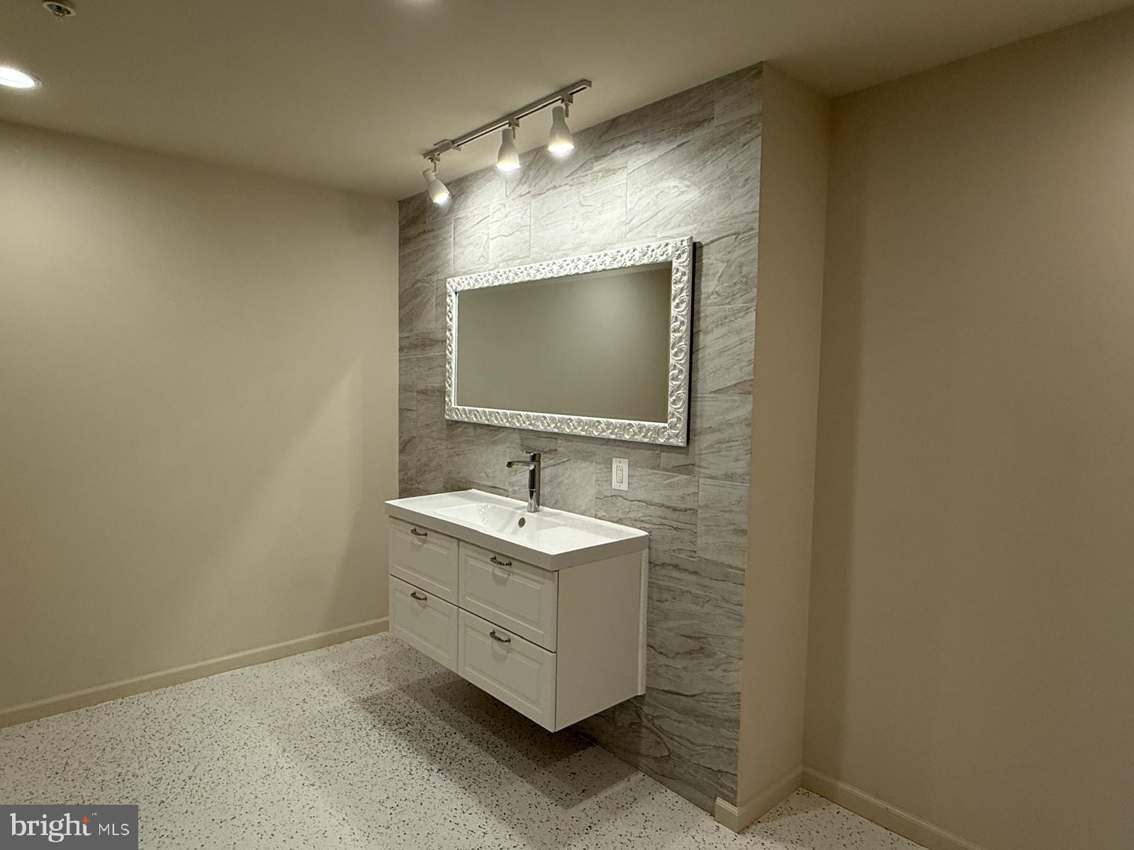 1108 Autumn Brook Avenue Silver Spring, MD 20906 - Photo 66 of 68 a bathroom with a sink and a mirror