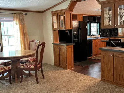 a kitchen with a counter space a sink and cabinets