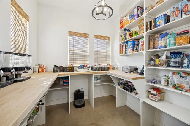 a kitchen with a sink a stove and a bookshelf