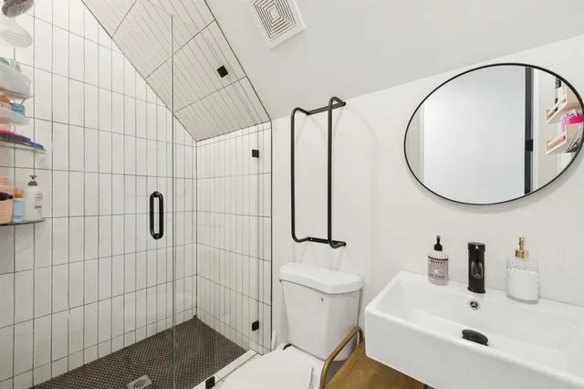 a bathroom with a sink toilet and shower