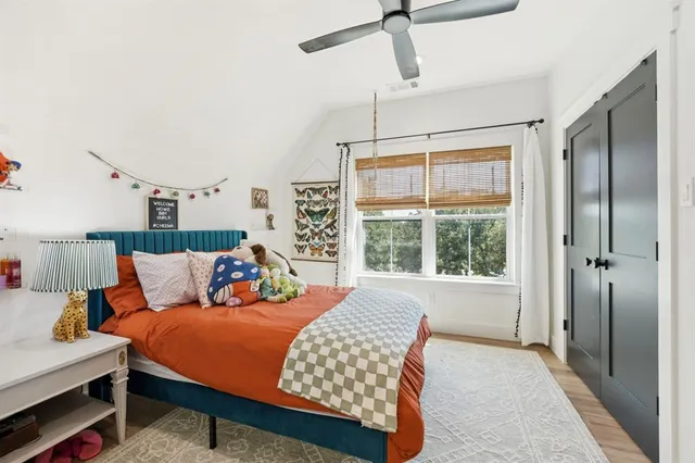 a bedroom with a bed and wooden floor