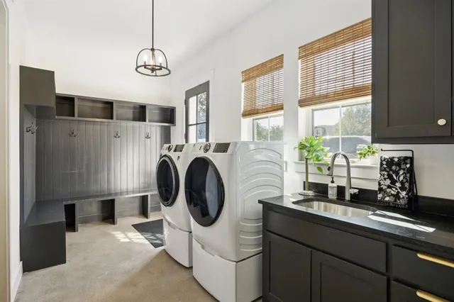 a kitchen with stainless steel appliances granite countertop a sink a stove and a refrigerator